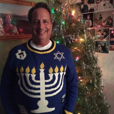 A picture of Leslie Lovitz's brother, John Lovitz, celebrating Hannukah and Christmas.